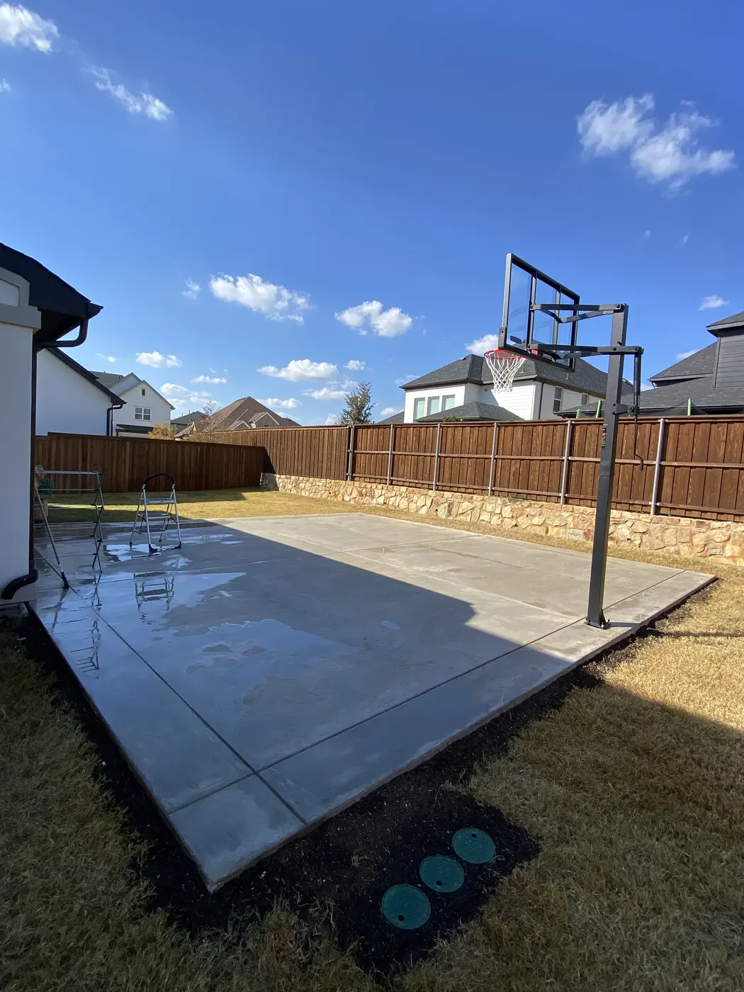 Finished concrete area with fencing and outdoor space