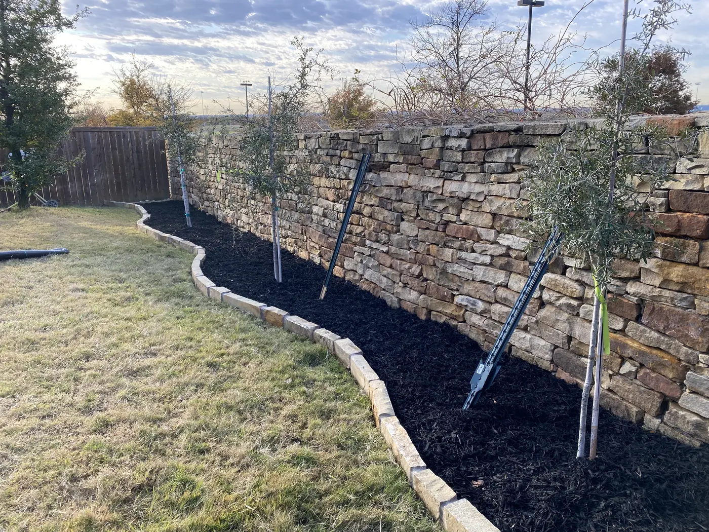 Decorative rock and mulch beds beside a swimming pool