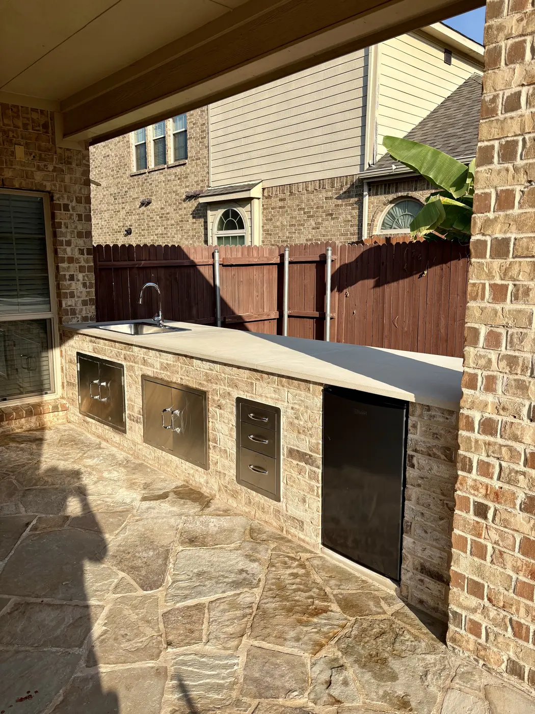 Stone outdoor kitchen with built-in appliances